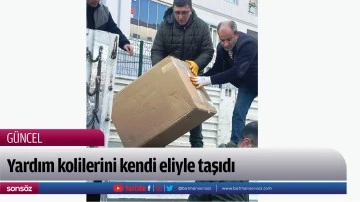 Yardım kolilerini kendi eliyle taşıdı